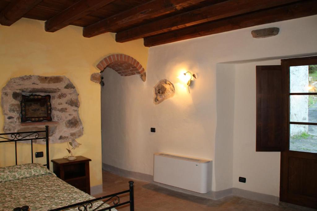 Postel nebo postele na pokoji v ubytování Agriturismo I Chiosi