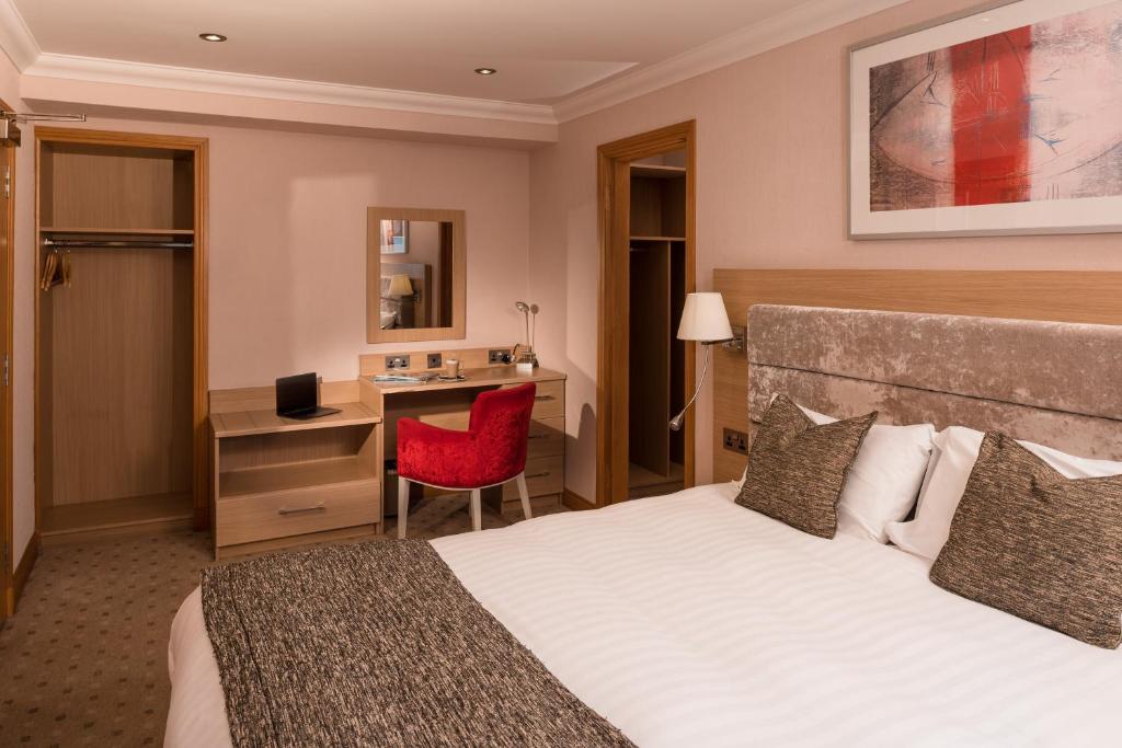 Postel nebo postele na pokoji v ubytování Carlton Hotel