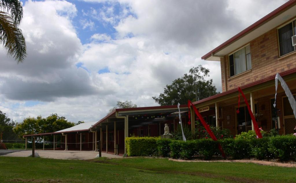 a building with red ribbon in front of it at Copper Country Motor Inn in Nanango