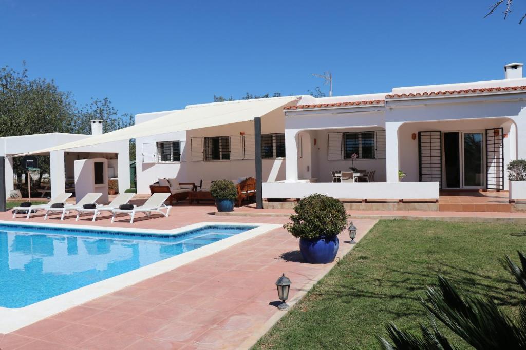 a villa with a swimming pool and a house at Villa Sa Vinyeta in Sant Llorenç de Balafia