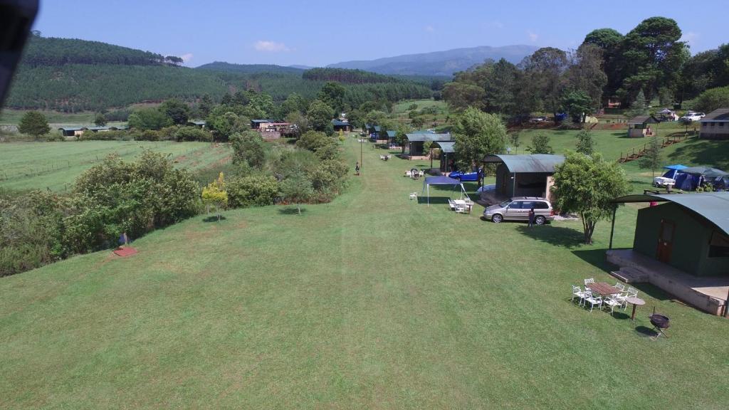 an aerial view of a large grass field with a group of tents at Sabie River Camp in Sabie
