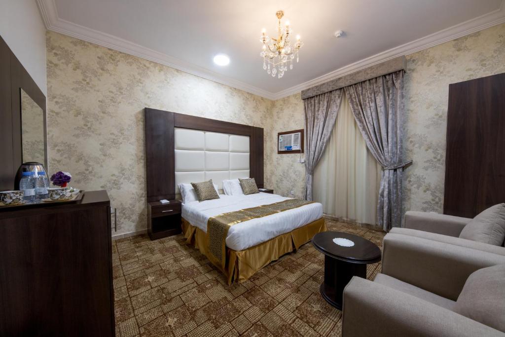 a hotel room with a bed and a couch at Jasmine Beach Hotel Suites in Yanbu