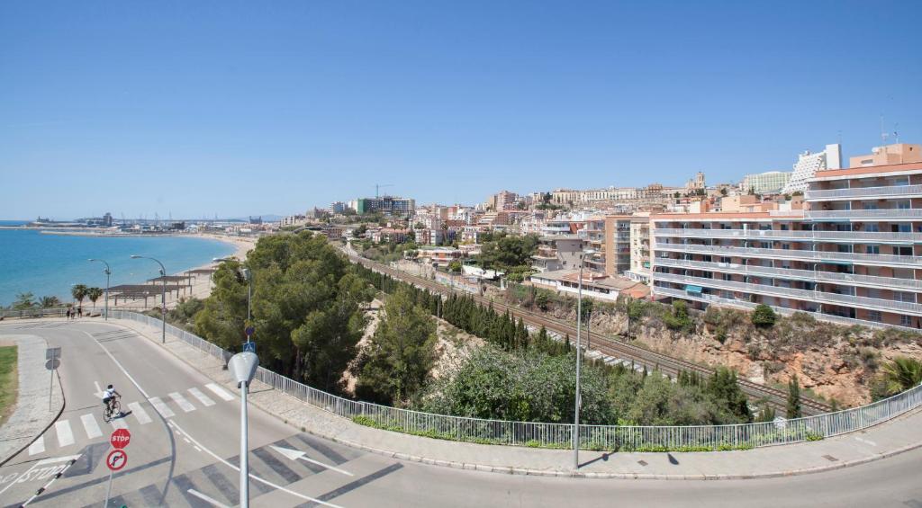a view of a city with a road and the ocean at Villa hortencia in Tarragona