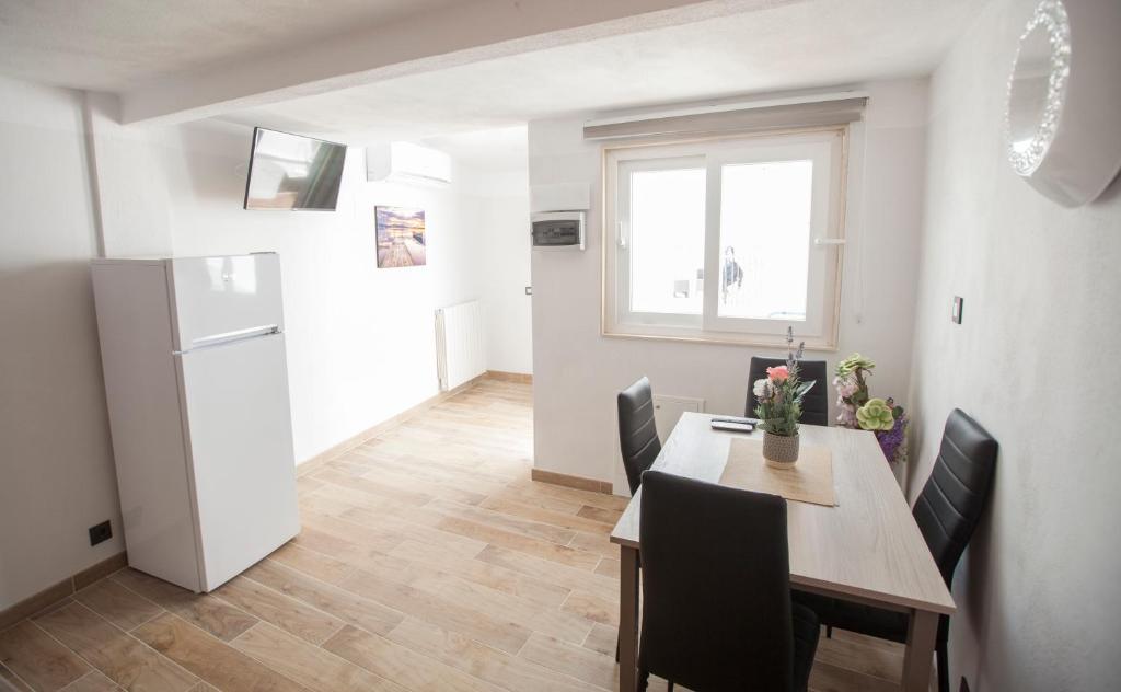 a kitchen and dining room with a table and a refrigerator at Villa hortencia in Tarragona