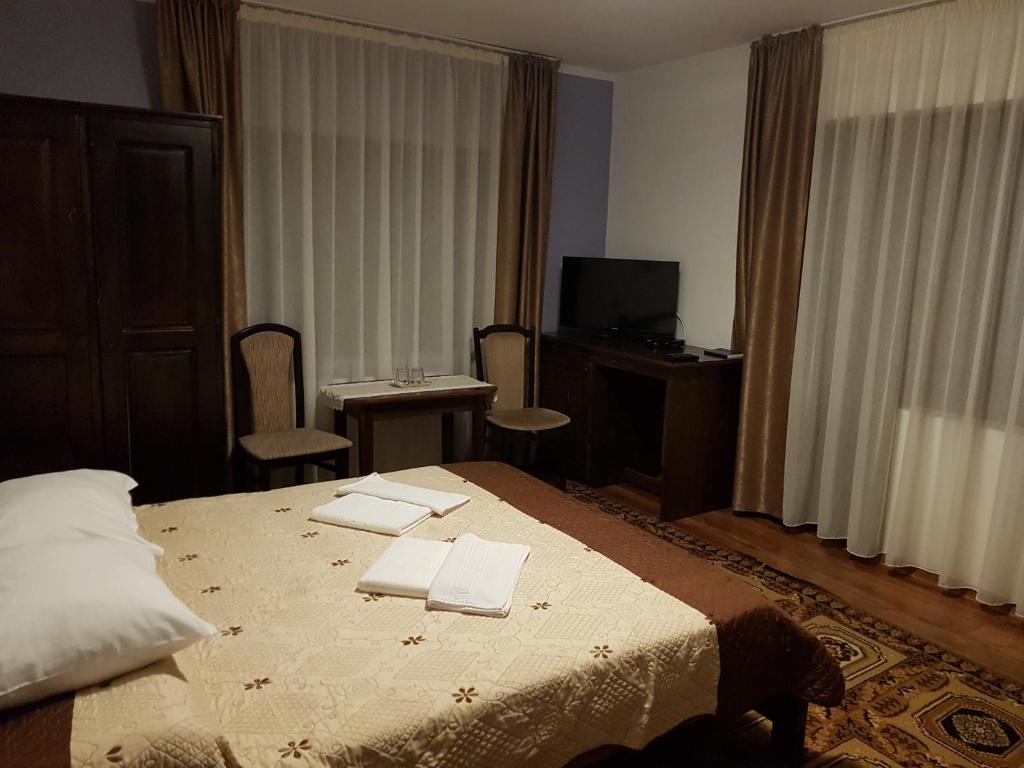 Postel nebo postele na pokoji v ubytování Perla Padurii