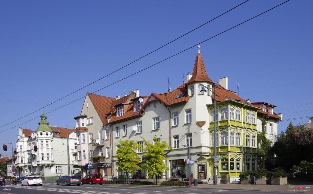 a large white building with a red roof at Podjazd in Sopot