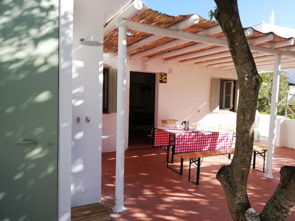 a view of a patio with a table and a pergola at Casa Típica Algarvia in Cabanas de Tavira