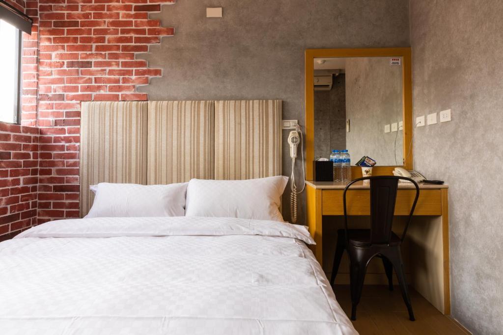 Postel nebo postele na pokoji v ubytování Longshan Inn