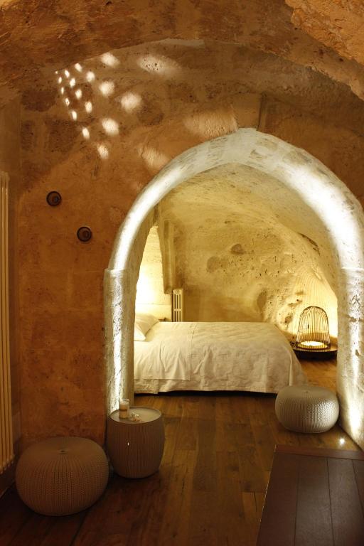 a bedroom with a bed in a stone room at Casa Linda in Matera