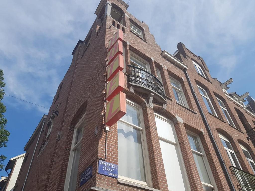 a building with a sign on the side of it at Hostel Cosmos Amsterdam in Amsterdam