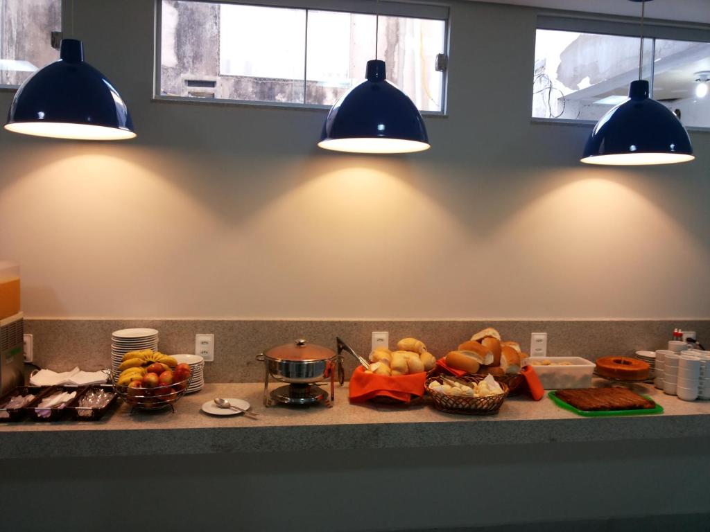 a kitchen counter with a bunch of food and lights at CITY HOTEL in Várzea Grande