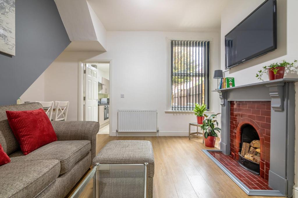 a living room with a couch and a fireplace at PLATFORM Fishing Quarter Apartment 1 in Hull