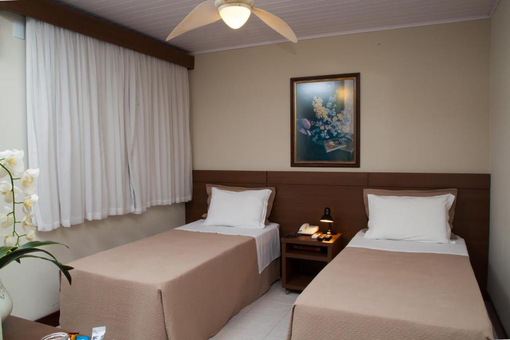 A bed or beds in a room at Príncipe Hotel