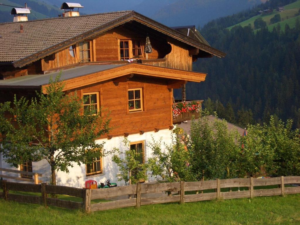 een houten huis met een hek ervoor bij Jägerhof in Alpbach