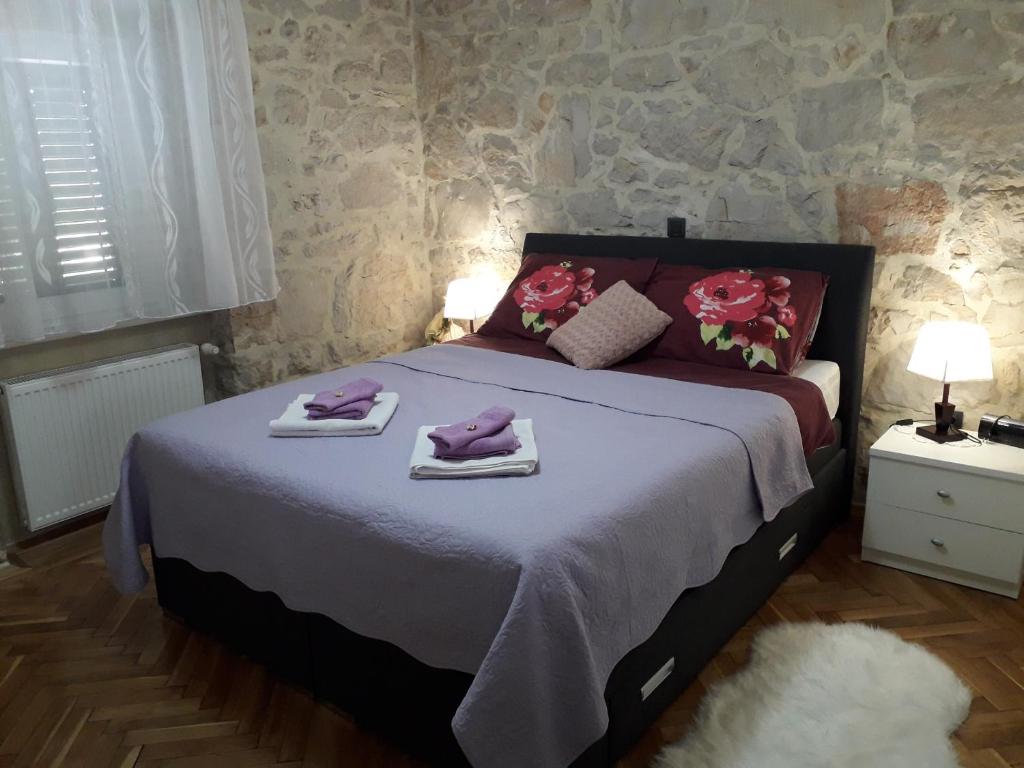 a bedroom with a bed with towels on it at Apartment Karla SNB in Lozovac
