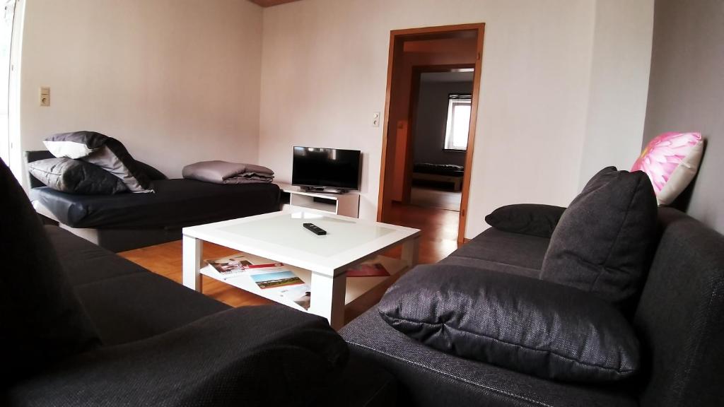 a living room with two couches and a white table at Fewo Fischer in Göppingen