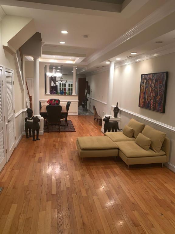 a living room with a couch and wooden floors at Bloomingdale Beauty near Union Station in Washington