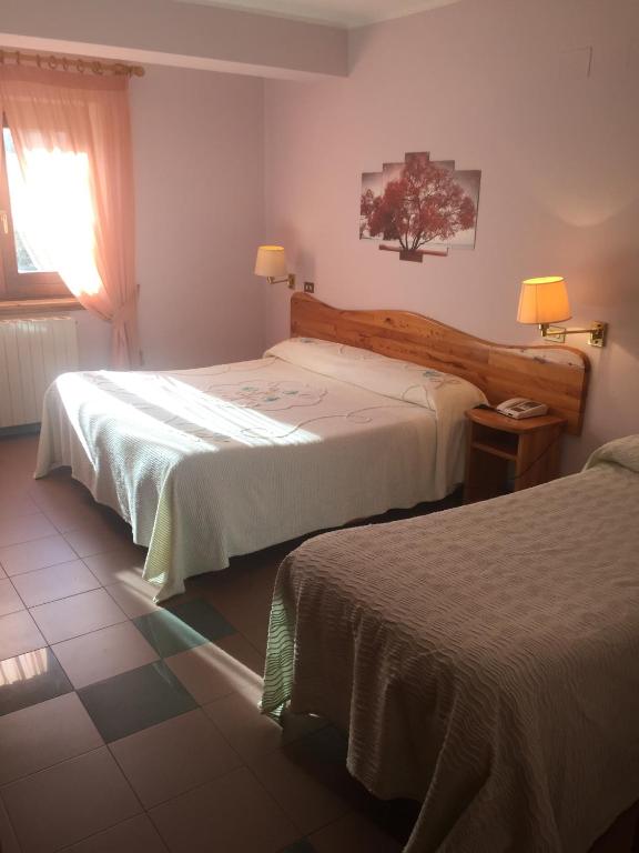 Postel nebo postele na pokoji v ubytování hotel lo sciatore