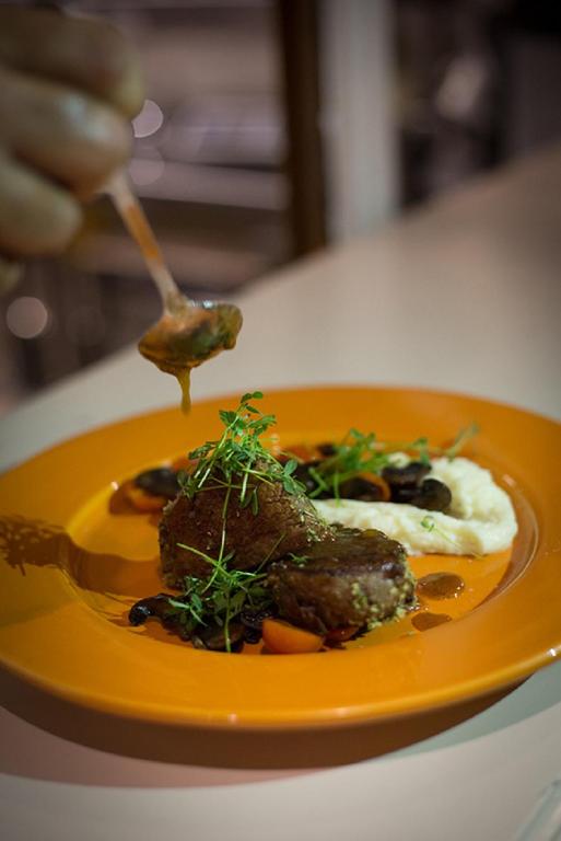 a plate of food with meat and vegetables on a table at Riad Challa Hotel & Spa in Marrakesh