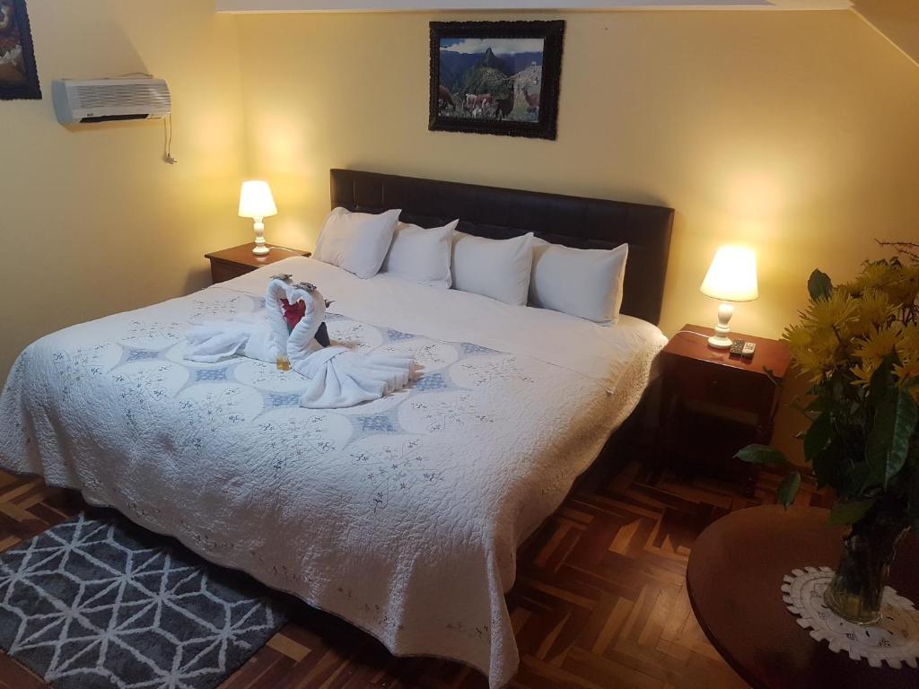 Postel nebo postele na pokoji v ubytování Hostal Wasichay