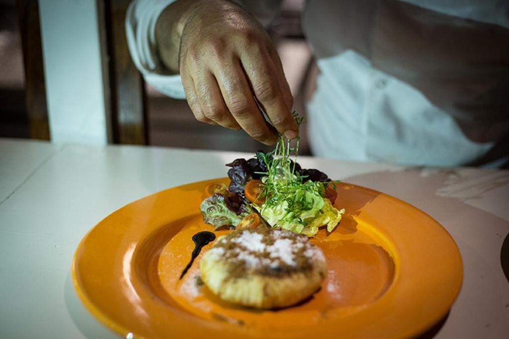 a person eating a plate of food on a table at Riad Challa Hotel & Spa in Marrakesh