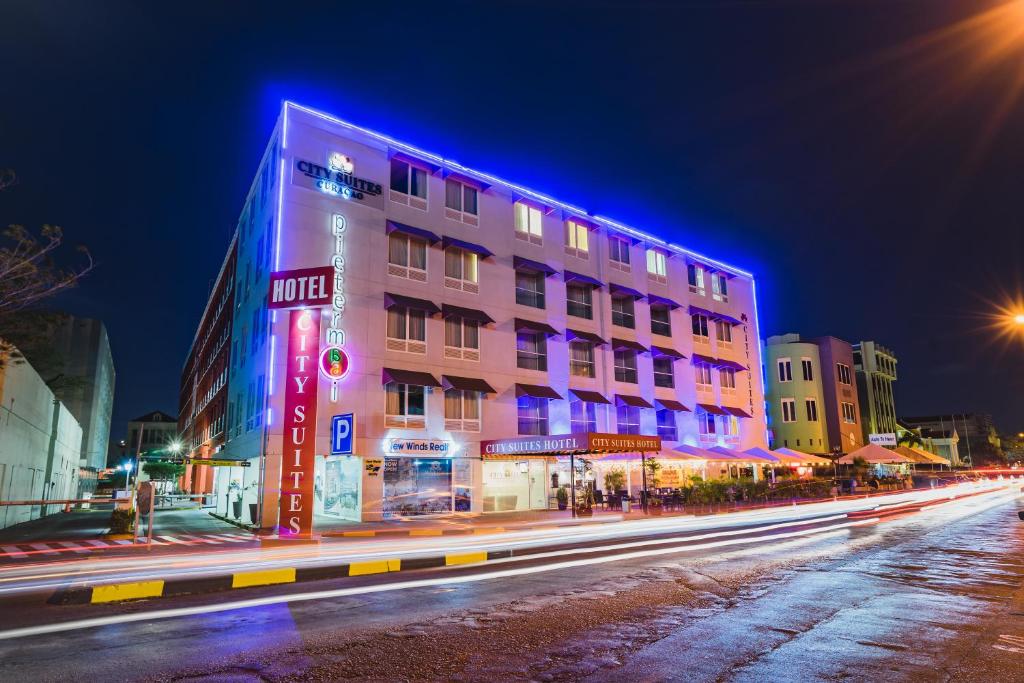 a building on a city street at night at City Suites & Beach Hotel in Willemstad