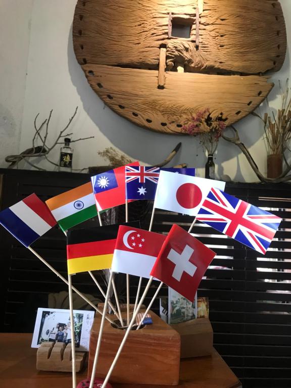 a bunch of different flags on a table at Bridge12th B&amp;B in Yanliau