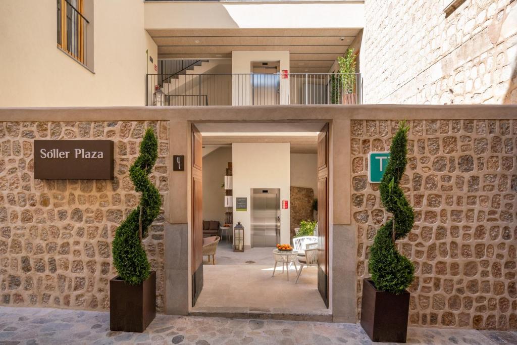a facade of a building with a sign for a patio at Soller Plaza in Sóller