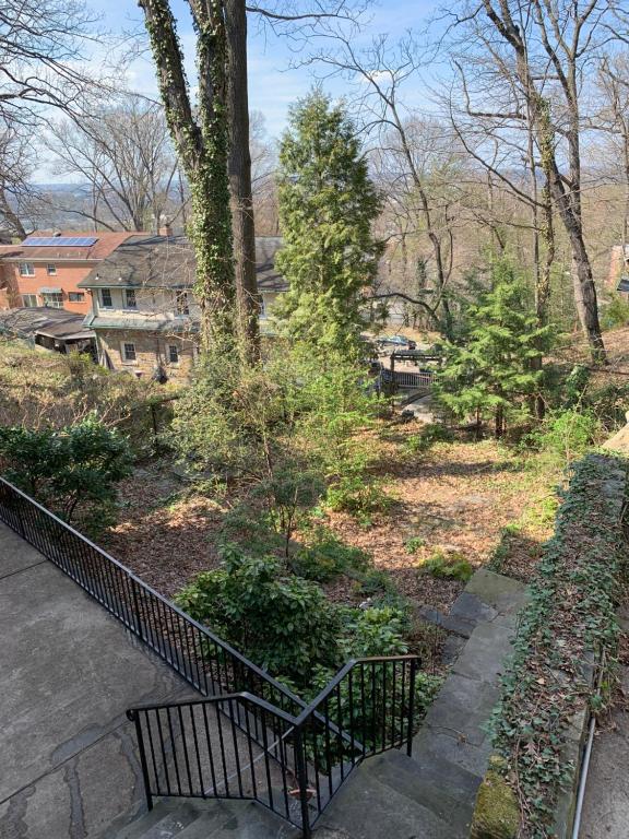 a park with a bench and trees and houses at Woody Westover in Hillcrest DC near Capitol Hill in Washington