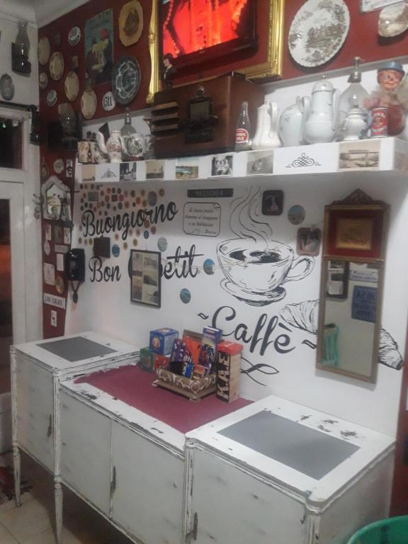 a counter in a kitchen with a wall covered in magnets at Hotel Florencia in Necochea