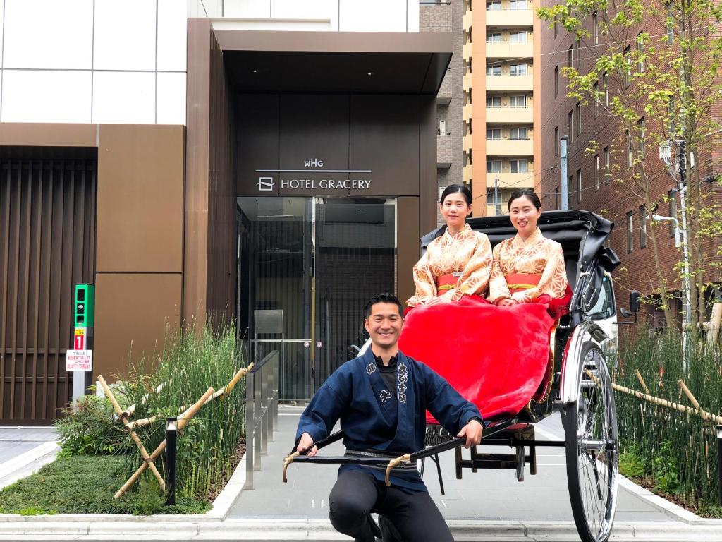 Een man die een riksja duwt met twee vrouwen erin. bij Hotel Gracery Asakusa in Tokyo