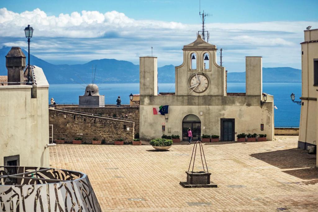 a building with a clock tower on top of it at Ginevra’s Apartment in Naples