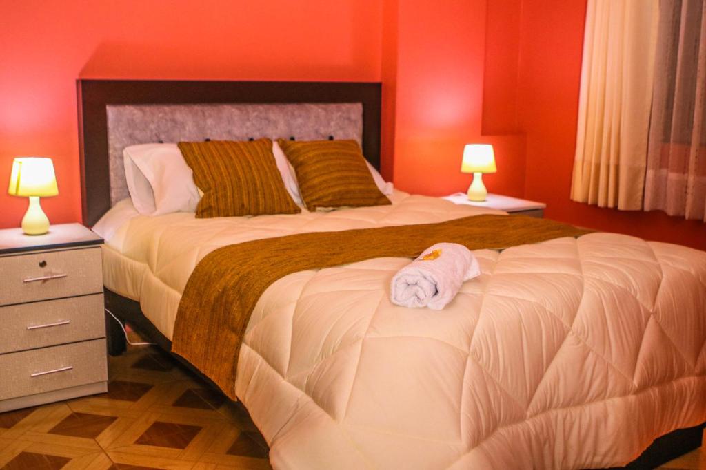 a bedroom with a large bed with a towel on it at Residencial el Valle in Huaraz