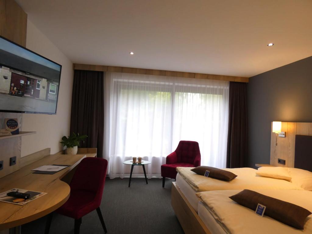 TV a/nebo společenská místnost v ubytování Akzent Hotel Cordes & Restaurant am Rosengarten