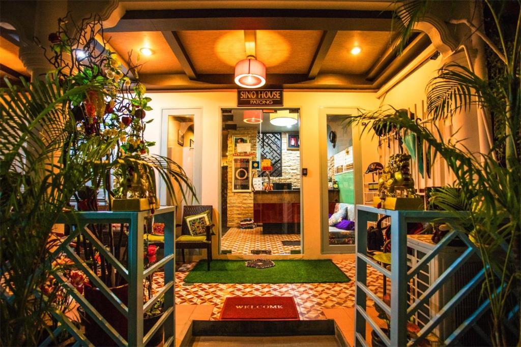 a entrance to a store with plants in theoyer at Sino House Patong in Patong Beach