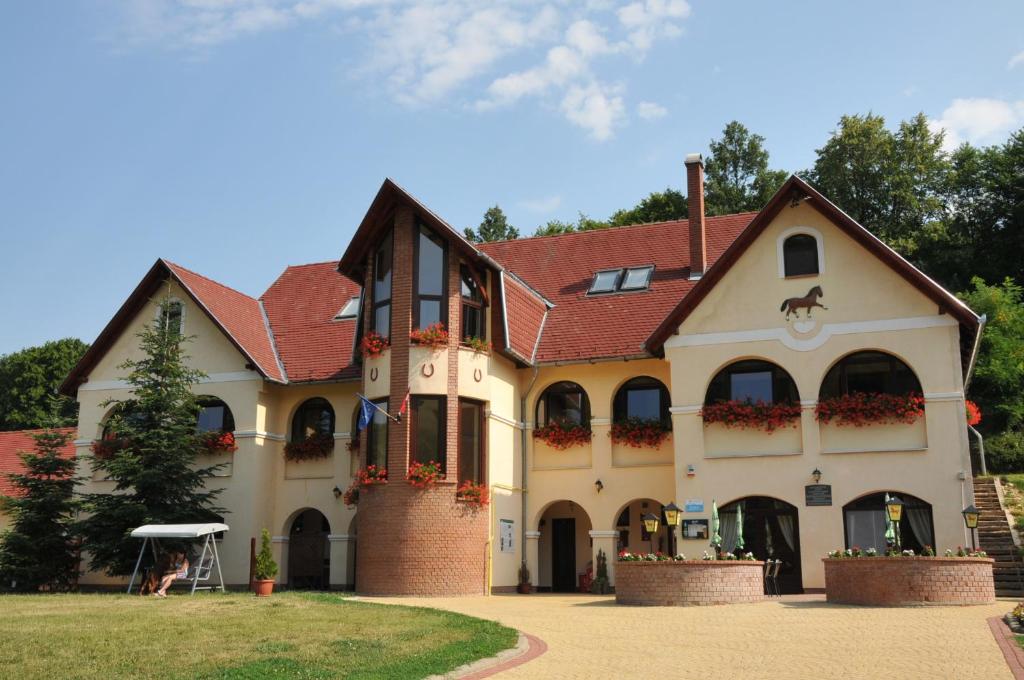 a large house with a red roof at Brauer Panzió in Mecseknádasd