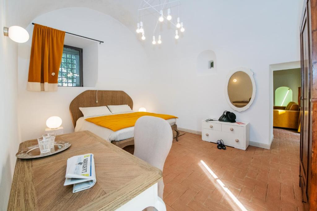 a small bedroom with a bed and a table and a table sidx sidx at Locanda La Fortezza in Finale Ligure