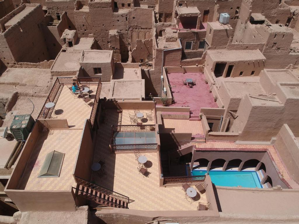 an aerial view of a building with a swimming pool at Gite Elkhorbat in Tinejdad