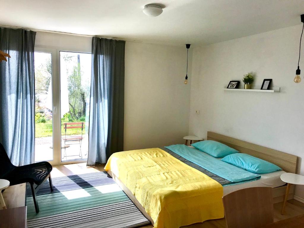 a bedroom with a bed and a large window at Apartments 57 in Portorož