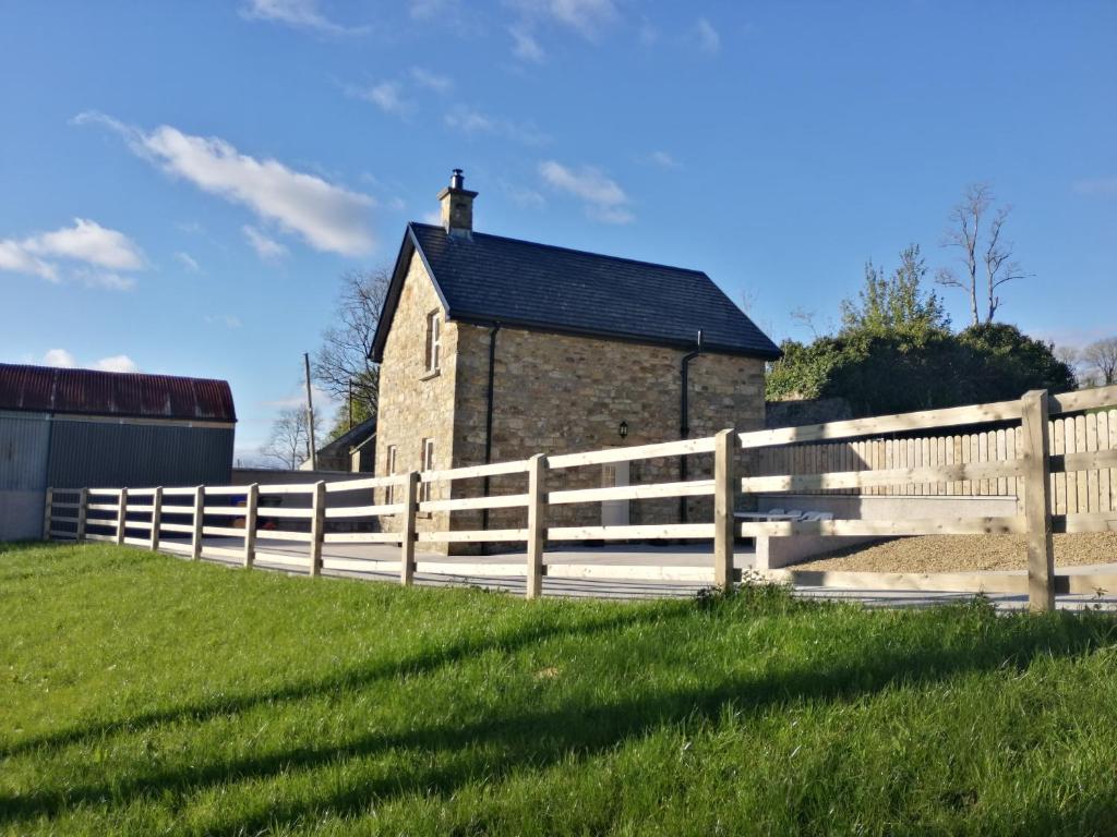 a wooden fence in front of a barn at Knockninny Barn at Upper Lough Erne, County Fermanagh in Enniskillen