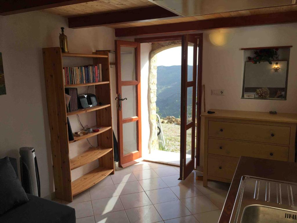 a kitchen with a door open to a room with a window at Contrada Carmine in Reitano