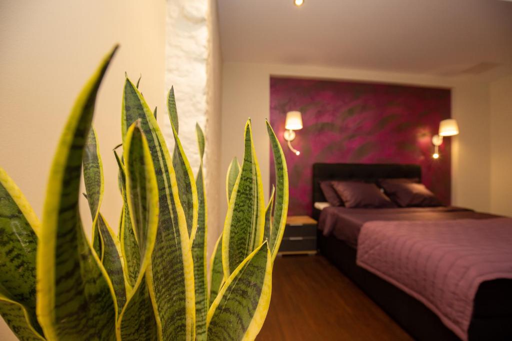 a bedroom with a bed and a potted plant at P54 Apartment in Paide