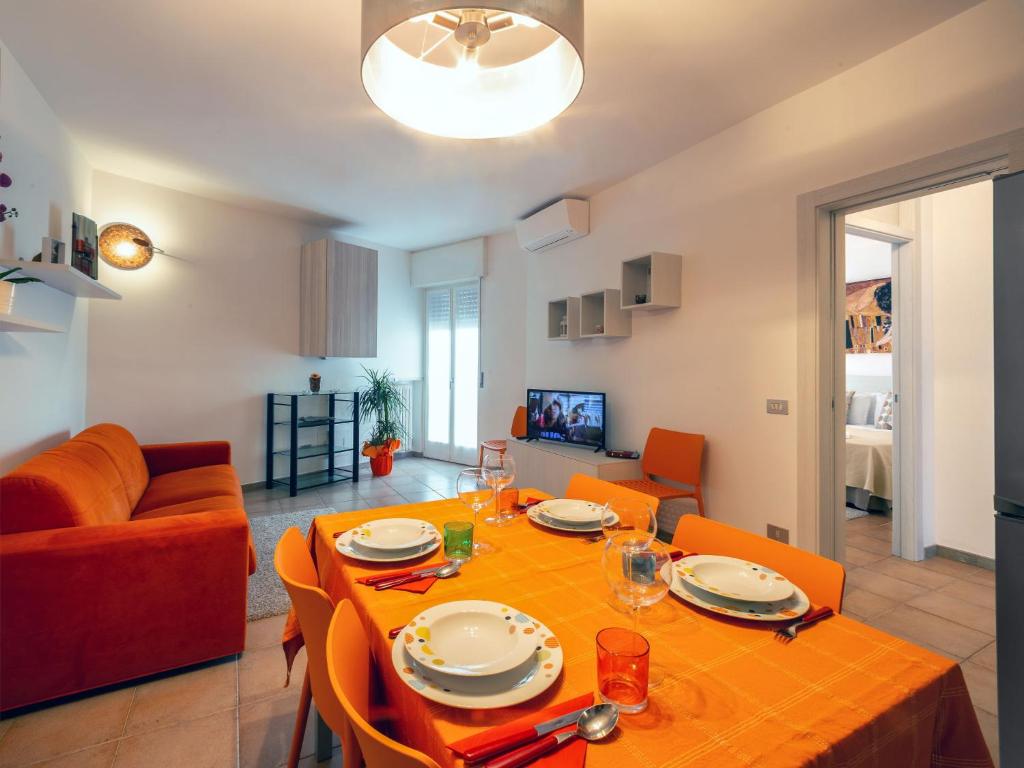 a dining room and living room with a table and chairs at Cabà Holiday Bardolino Gritti in Bardolino