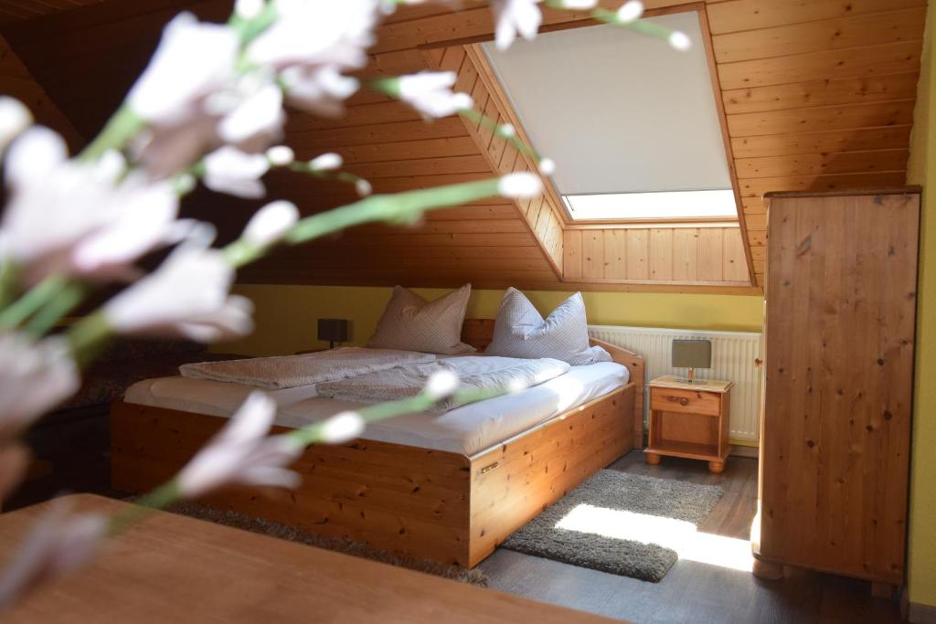 a bedroom with a bed in a wooden room at Landgasthof Am Teufelstisch in Hinterweidenthal