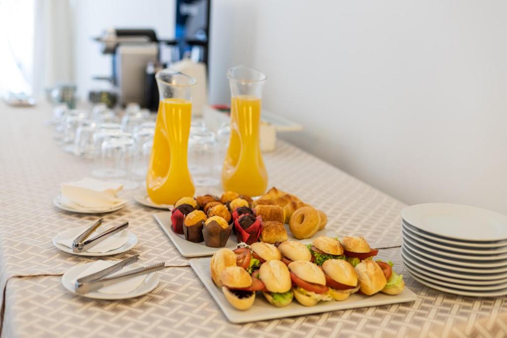 a table with two plates of food and two glasses of orange juice at Hotel LIVVO Volcán Lanzarote in Playa Blanca