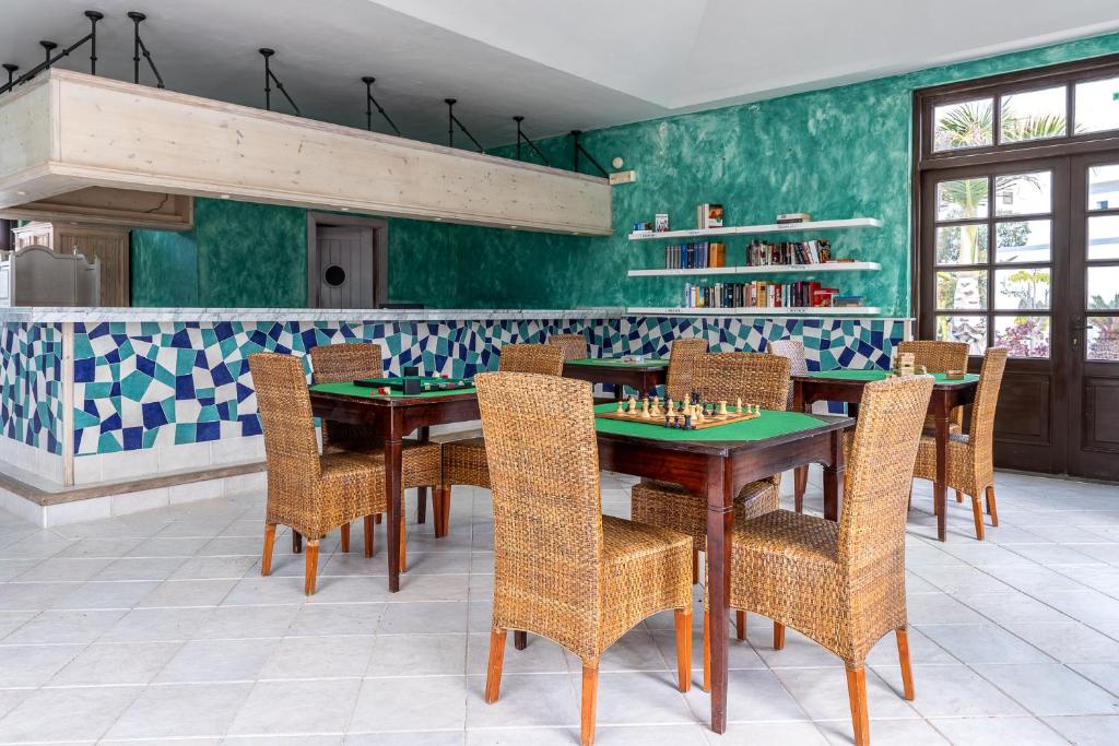 a dining room with a table with chessetts on it at Hotel LIVVO Volcán Lanzarote in Playa Blanca