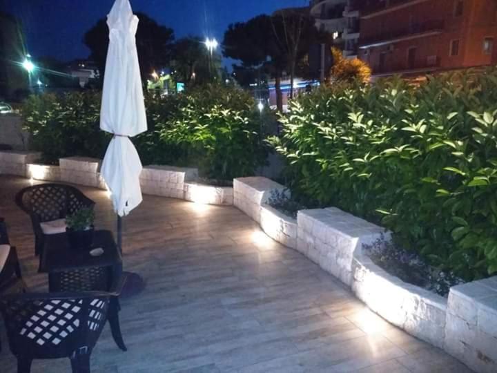 an umbrella and chairs on a patio at night at Casa vacanze margo' in Monopoli