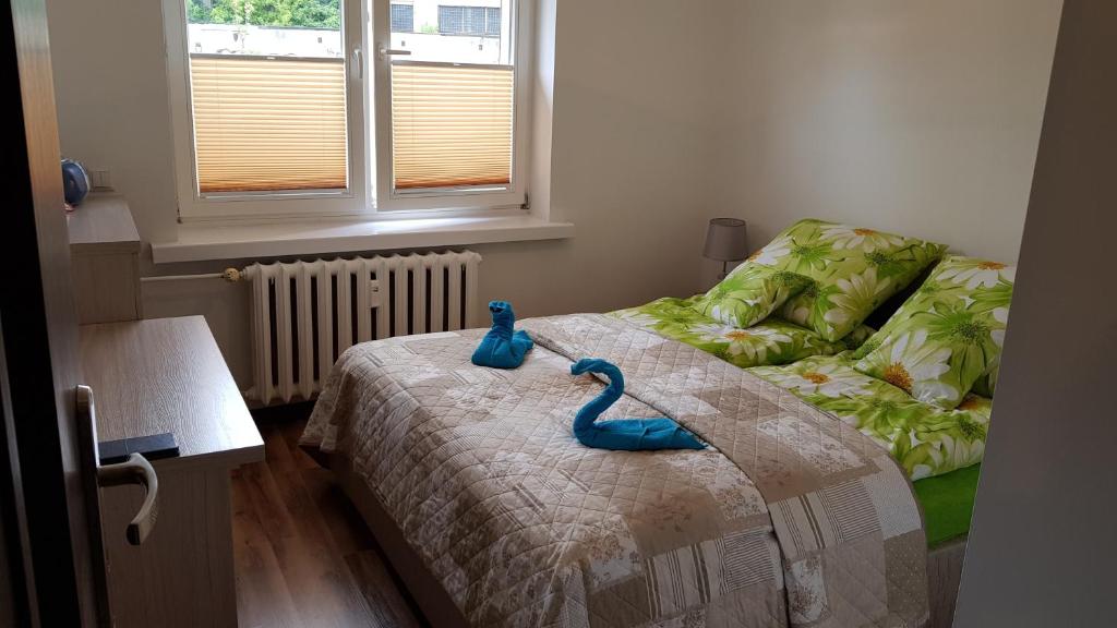 Un dormitorio con una cama con un cisne de juguete. en de Gaulle'a 20, en Zabrze