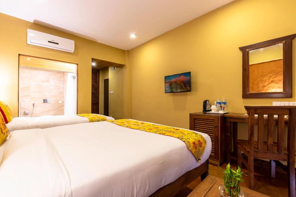 Postel nebo postele na pokoji v ubytování Hotel Mala Pokhara