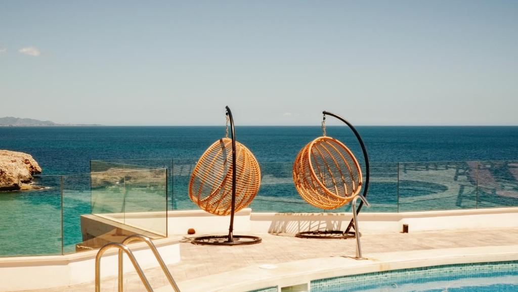 a swimming pool with a view of the ocean at ICON Valparaiso - Adults Only in Cala Murada
